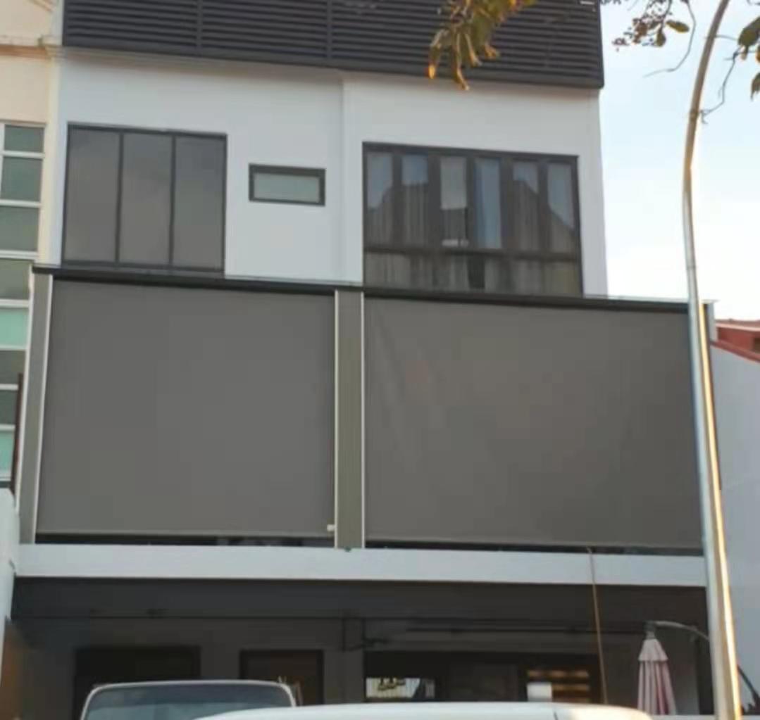 Outdoor roller blinds installed on modern house balcony in Singapore